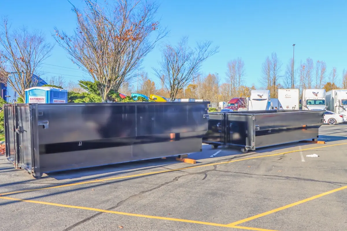 Professional dumpster rental service with roll-off container on residential driveway in Redondo Beach